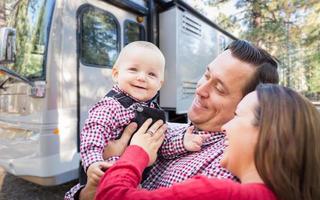 contento giovane caucasico famiglia nel davanti di loro bellissimo rv a il campeggio. foto