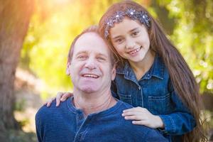 carino giovane misto gara ragazza e caucasico nonno avendo divertimento all'aperto foto