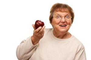 attraente anziano donna con rosso Mela foto