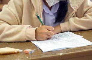 asiatico studenti siamo assunzione esami per misurare apprendimento nel il aula. morbido e selettivo messa a fuoco. foto