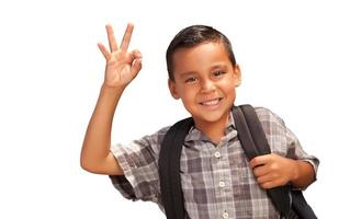 contento giovane ispanico ragazzo dando un va bene mano cartello con zaino pronto per scuola isolato su un' bianca sfondo. foto