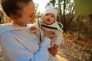 bellissimo giovane mamma con bambino nel autunno foto