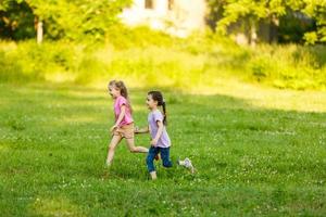 Due poco ragazze a piedi nel il campo. foto