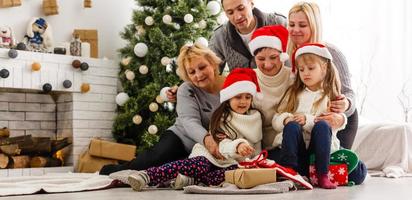 contento giovane famiglia Tenere Natale regalo e sorridente foto