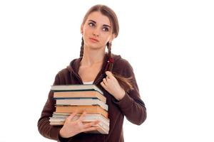 stanco giovane studenti ragazza con libri nel sua mani isolato su bianca sfondo foto