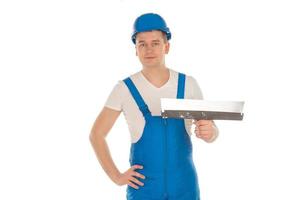 costruttore nel blu uniforme con mastice coltello foto
