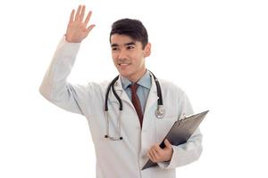allegro bello uomo medico in posa nel uniforme isolato su bianca sfondo nel studio foto