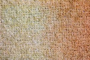 a maglia lana tessile strutturato sfondo nel leggero beige cremoso Marrone ombra. beige colore pendenza su struttura sfondo. foto