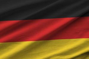 Germania bandiera con grande pieghe agitando vicino su sotto il studio leggero al chiuso. il ufficiale simboli e colori nel bandiera foto