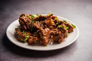 sukha montone o pollo, asciutto speziato murgh o capra carne servito nel un' piatto o ciotola foto