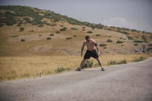 giovane uomo corridore in esecuzione su un' montagna strada. jogger formazione allenarsi nel fitness scarpa. salutare stile di vita e sport concetto. movimento sfocatura e selettivo messa a fuoco. foto