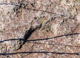 vicino su Visualizza a un' granito e pietra parete struttura nel un' alto risoluzione. foto