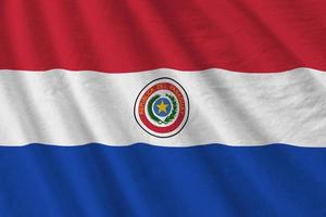 paraguay bandiera con grande pieghe agitando vicino su sotto il studio leggero al chiuso. il ufficiale simboli e colori nel bandiera foto