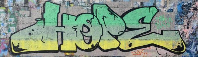 frammento di graffiti disegni. il vecchio parete decorato con dipingere macchie nel il stile di strada arte cultura. colorato sfondo struttura nel verde toni foto