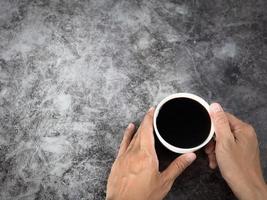 mano Tenere nero caffè tazza buio sfondo superiore Visualizza foto