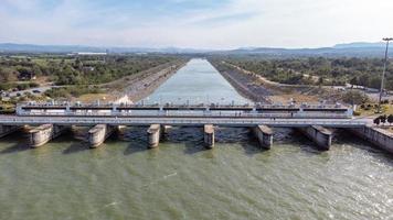 un aereo Visualizza al di sopra di il pasak jolasid diga, lopburi Provincia, Tailandia. puntamento il movimento di il chiuse quello siamo rilasciando acqua in rurale canali nel enorme importi di acqua. foto