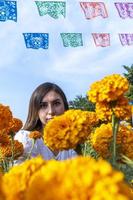 giovane donna di Pentecoste tradizionale cempasuchil fiori Usato per altari a giorno di il morto nel Messico foto