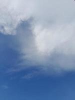 bellissimo bianca nuvole su in profondità blu cielo sfondo. elegante blu cielo immagine nel luce del giorno. grande luminosa morbido soffice nuvole siamo copertina il intero blu cielo. foto