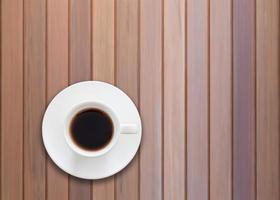 vista dall'alto di una tazza di caffè su fondo in legno