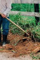 non identificabile azienda agricola lavoratore taglio erbacce con un' Zappa nel un' azienda agricola foto