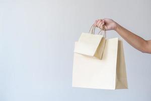 donna trasporto carta Borsa concetto di riutilizzare, riciclare il oggetto per zero sciupare. concetto di sostenibilità utilizzando di riciclato carta borse per acquisti. foto