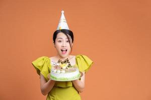 giovane asiatico donna Tenere compleanno torta foto