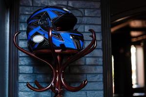 motociclo casco riposa su un' appendiabiti foto