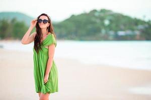 giovane bellissimo donna su tropicale spiaggia. contento ragazza rilassante a bianca sabbia tropicale spiaggia foto
