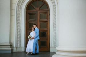 sposa nel un' leggero nozze vestito per il sposo nel un' blu completo da uomo foto