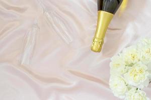 San Valentino giorno concetto, Champagne con bicchiere e bianca peonia su tavolo stoffa per commensale foto
