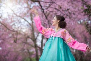 hanbok, il tradizionale coreano vestito e bellissimo asiatico ragazza con sakura foto