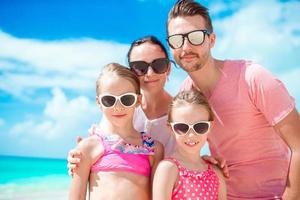 ritratto di contento bellissimo famiglia su bianca spiaggia foto