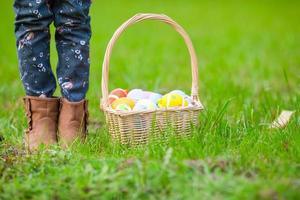 avvicinamento cestino pieno di colorato Pasqua uova nel bambini mani foto