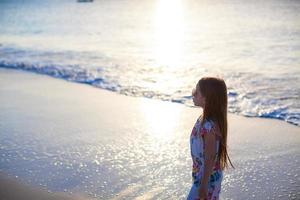 adorabile poco ragazza a piedi a bianca tropicale spiaggia foto