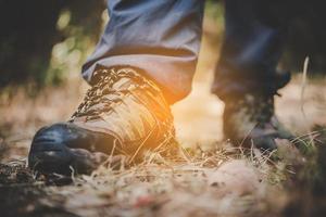 primo piano dei piedi di un uomo escursioni su un sentiero di montagna foto