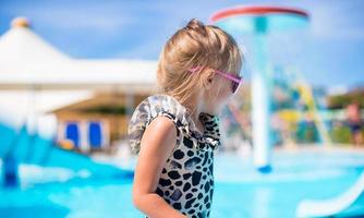 poco ragazza a Parco acquatico durante estate vacanza foto