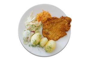 Maiale cotoletta con patate e insalata foto