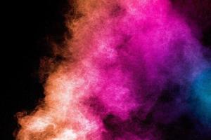 lanciato polvere multicolore su sfondo nero.esplosione di polvere colorata.spruzzi di polvere colorati. foto