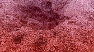 sfondo di il rosso colore di il struttura e modello di il sabbia pavimento. foto