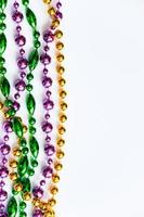 mardi gras sfondo. oro, verde e viola perline su bianca sfondo. Grasso martedì simbolo. foto