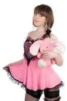 giocoso ragazza nel un' rosa vestito con il elefante vitello foto