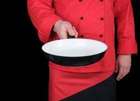 cucinare nel rosso uniforme Tenere un vuoto il giro bianca frittura padella foto