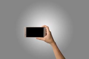 primo piano della mano di una donna che tiene un telefono isolato su sfondo bianco foto