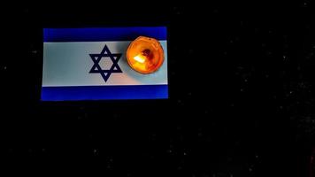 israeliano bandiera e candele ardente sopra esso, olocausto memoria giorno foto