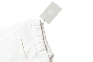 carta etichetta su un' bianca 100 per cento biologico cotone pantaloni della tuta foto