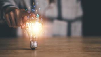 soluzione concetto e dimostrando comando strategie, quello condurre il attività commerciale nel un' riuscito direzione, con innovazione e cervello energia a partire dal brainstorming, leggero lampadina nel umano mano foto