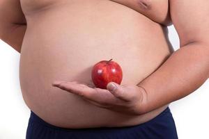 uomo grasso con una mela in mano foto