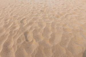 impronte su sabbia e sabbia struttura e sfondo foto