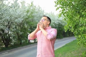 un' uomo chi ha guaio starnutire. effetti di polline su Salute. foto