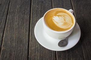 tazza di latte macchiato caffè su legna foto